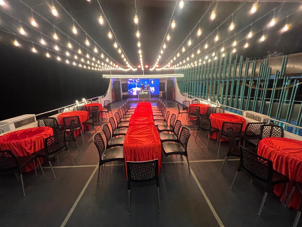 Event setup aboard Calma Cruise with stage and dining